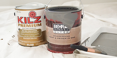 Gallon cans of BEHR PREMIUM PLUS ULTRA paint and KILZ Premium primer