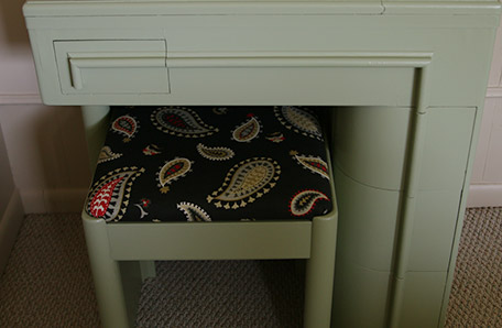 Close-up of the desk and stool, with new paint and paisley upholstery