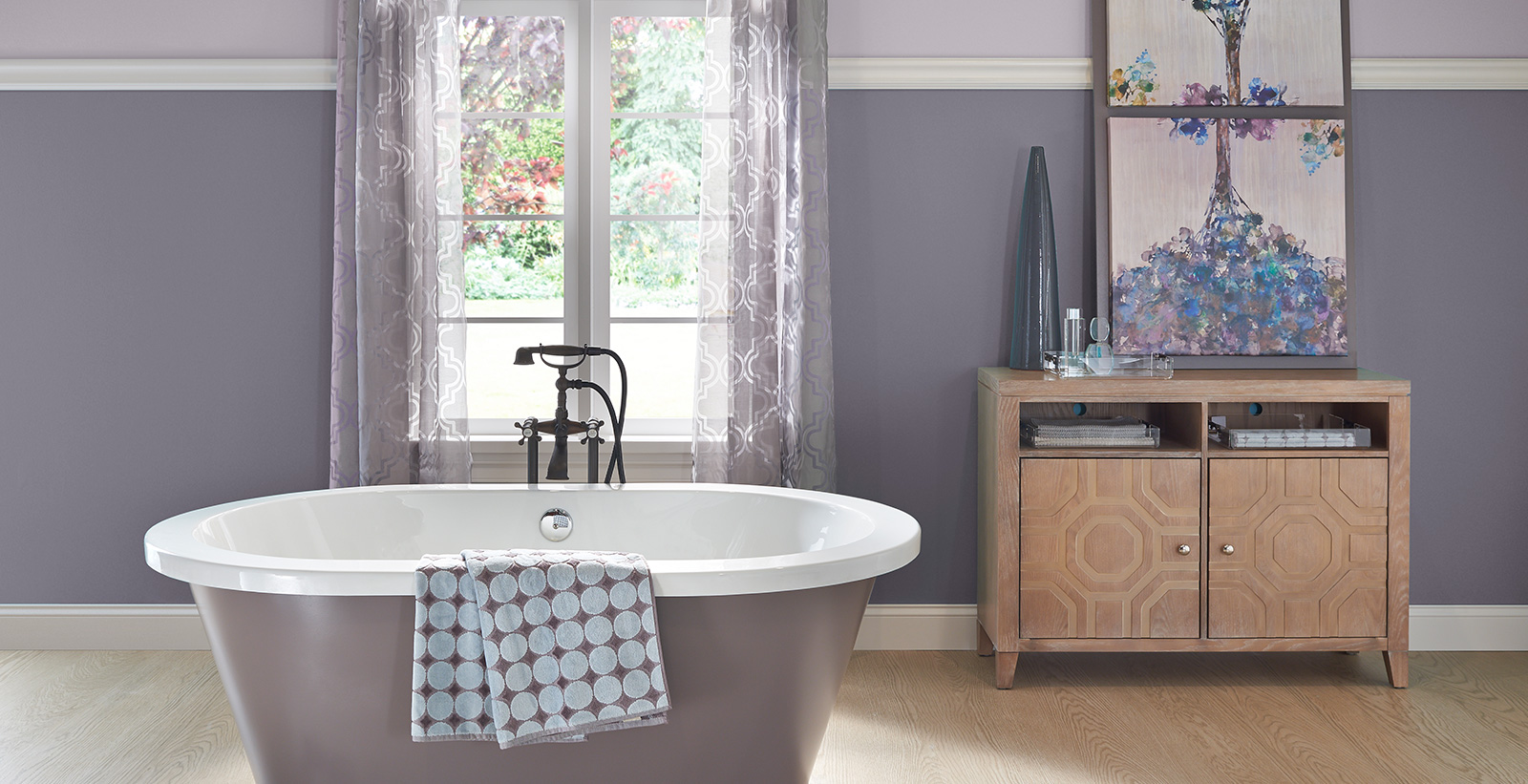 Relaxed and calming styled bathroom with purple walls and white trim.