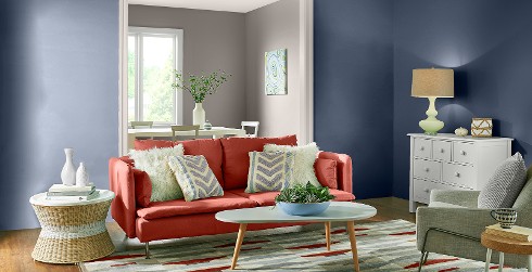 Mid-century living room with blue on walls, white on trim, and red couch
