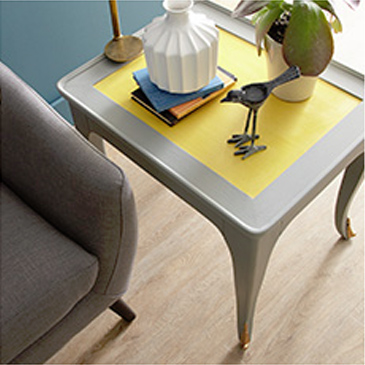 Dark gray chair next to gray and yellow table