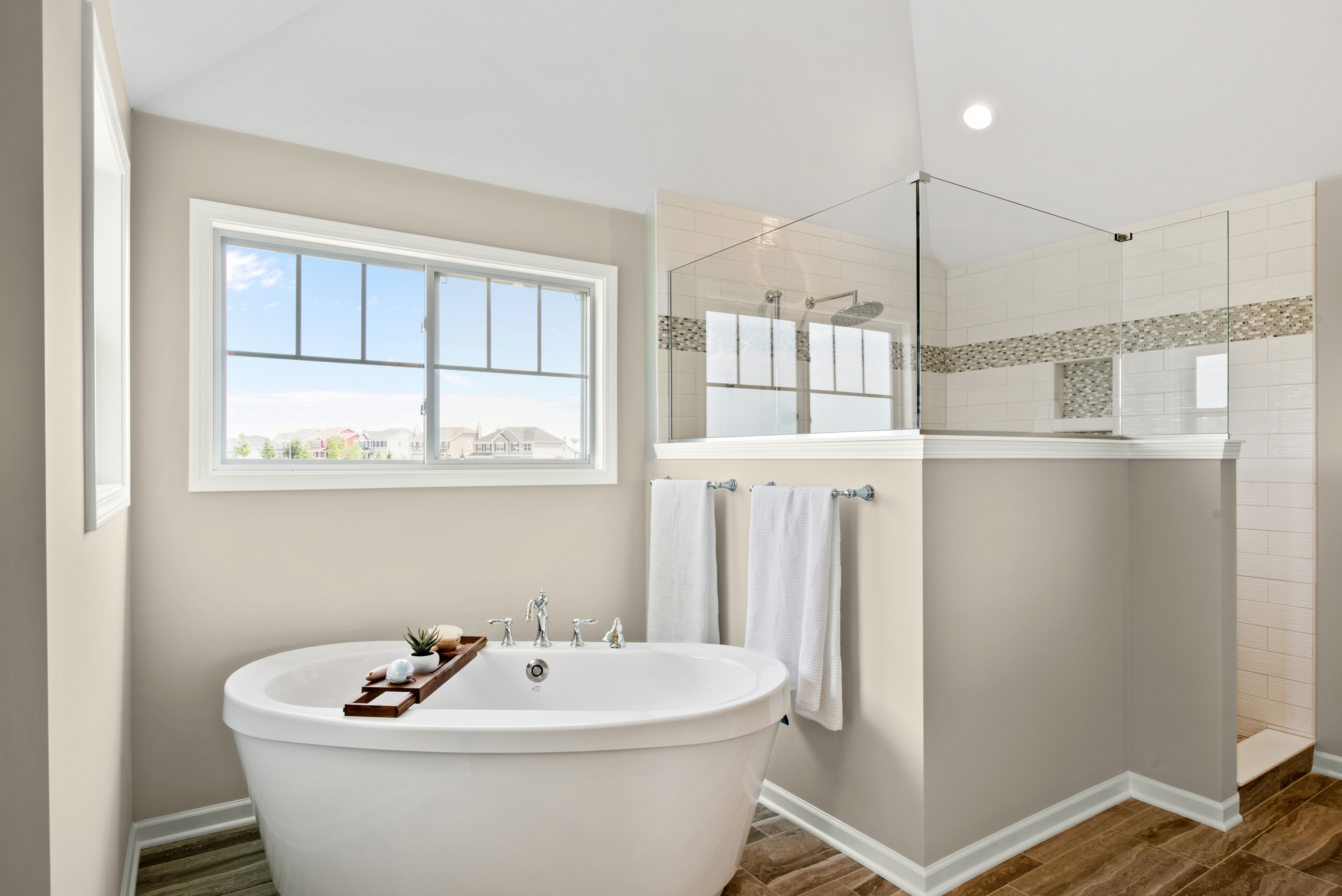 Une grande salle de bain peinte en Encore plus beige, avec douche et baignoire distinctes comme un spa-maison.
