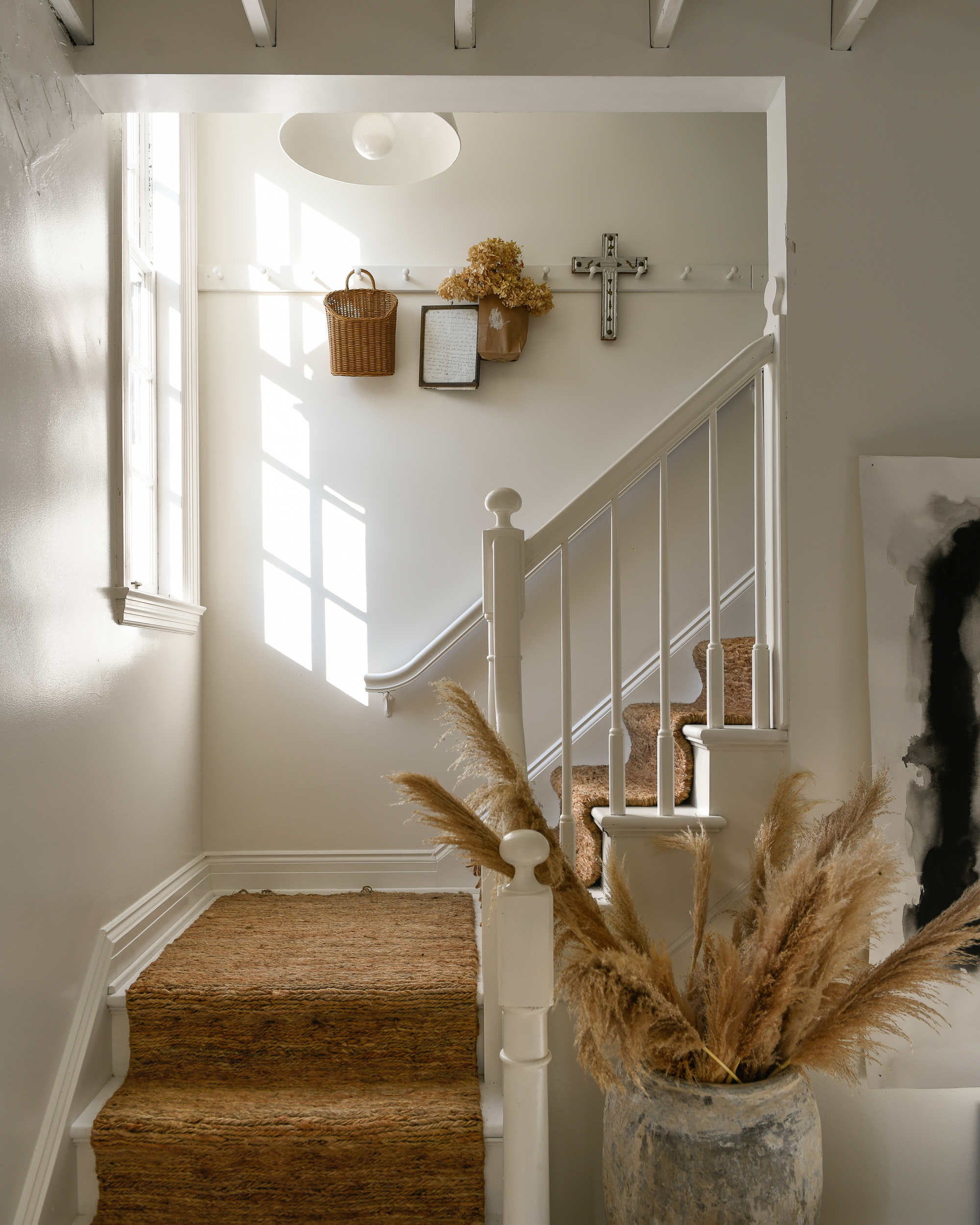 L'escalier de Leanne Ford, dont les murs sont peints en Blanc naturel et agrémentés d'accents bruns