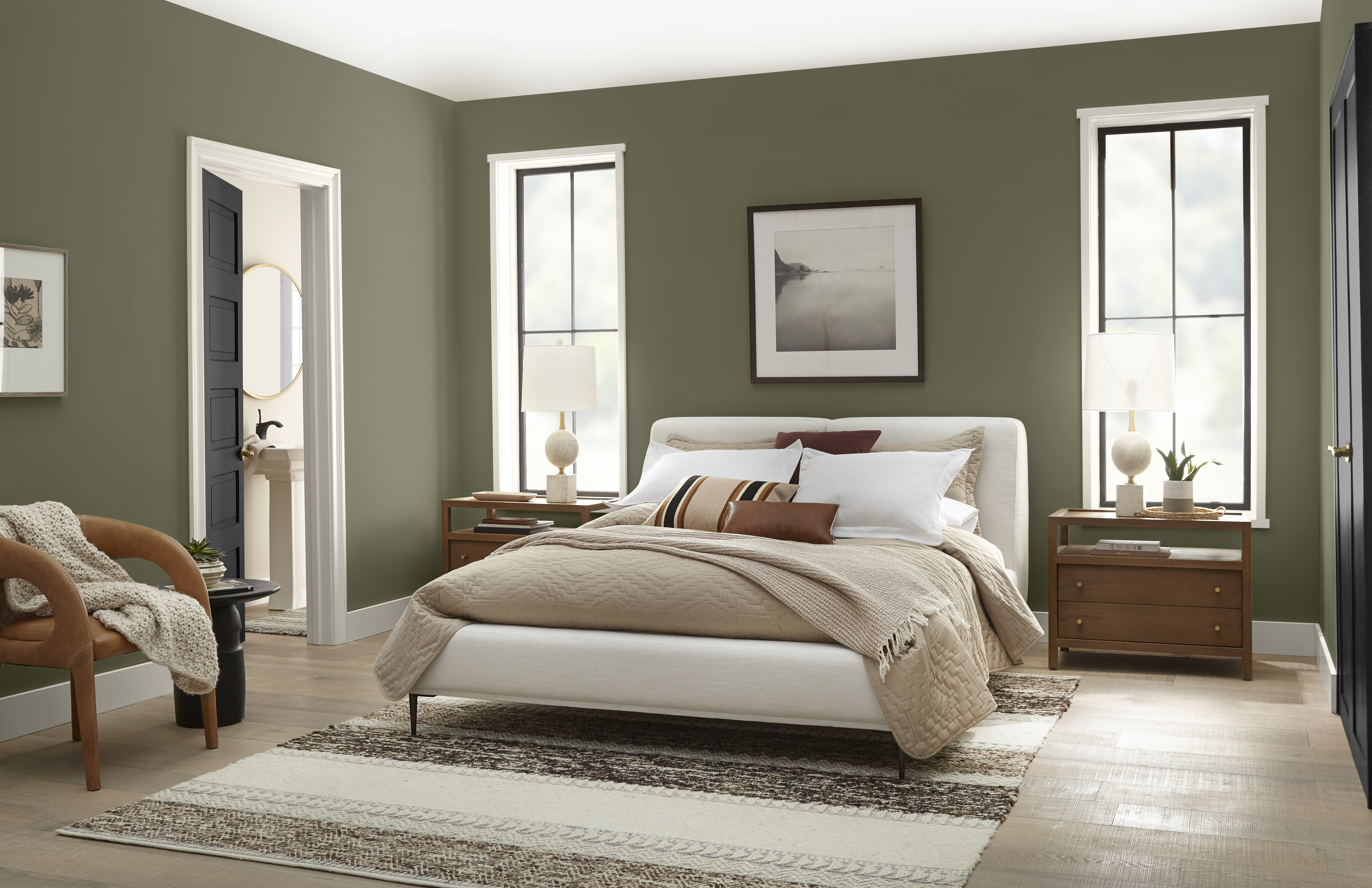 Une chambre à coucher confortable avec des murs peints dans un vert foncé chaud
